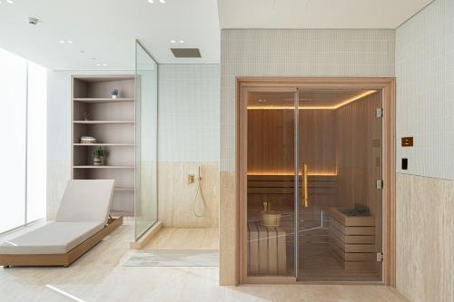 a bathroom with a shower and a glass door at Iconic Binghatti Royale! Private Pool in Your Balcony! 5 Star Amenities! in Dubai