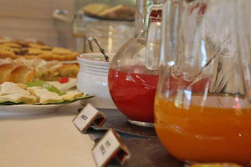 un tavolo con due bicchieri di tè e un piatto di cibo di Garni Sayonara a Moena