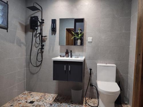a bathroom with a toilet and a sink and a shower at Forest Pool Villa in Ulu Melaka