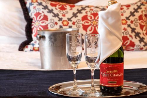 a bottle of wine and two glasses on a table at The Marshall House, Historic Inns of Savannah Collection in Savannah