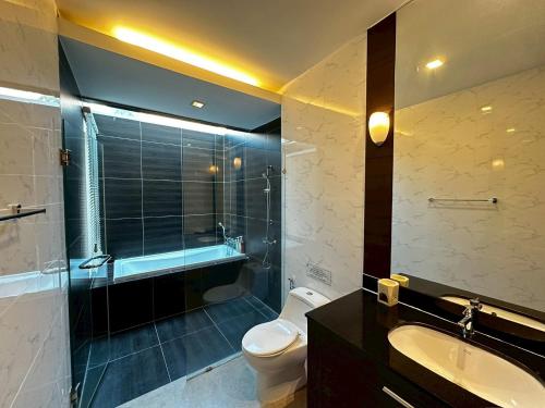 a bathroom with a toilet and a shower and a sink at The Villa Jomtien Pattaya By Ahmed in Jomtien Beach