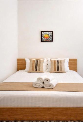 a bedroom with a bed with two towels on it at Old Quarter Lake House in Hanoi