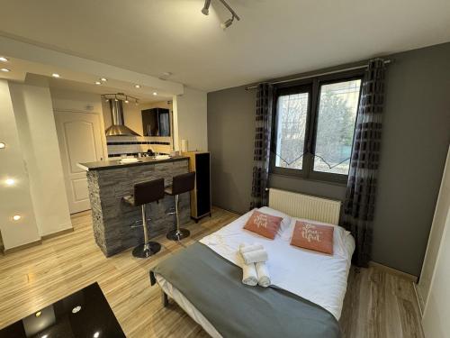 a bedroom with a bed and a kitchen in it at Studio fonctionnel Beauvais in Beauvais