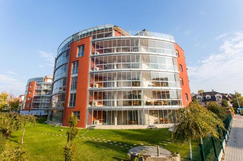 a tall red building with a lot of windows at Luxury Apartment Hotel Siófok in Siófok
