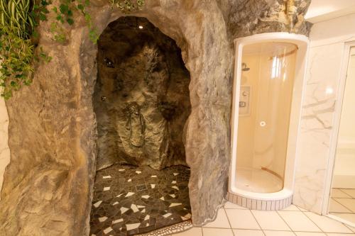 ein Badezimmer mit einer Dusche in einer Felswand in der Unterkunft Hotel Neder in Ischgl