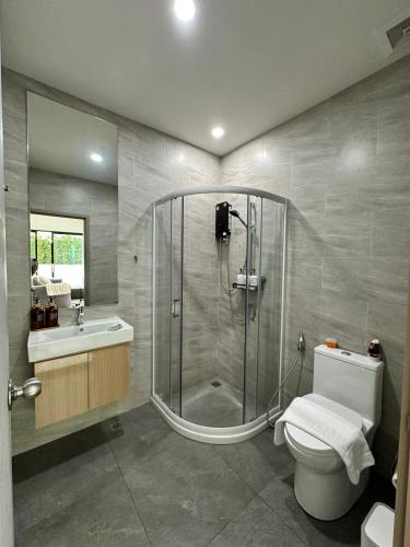 a bathroom with a shower and a toilet and a sink at 2 Bedroom Modern House in Ban Nong Chaeng