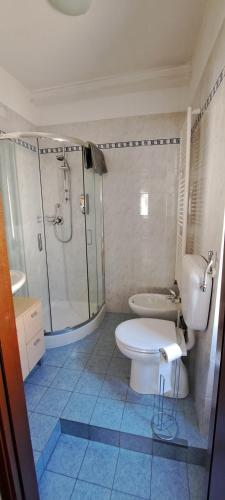 a bathroom with a white toilet and a shower at La Casetta - Locazione turistica in Voltaggio
