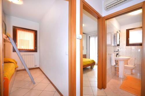 a room with a bathroom with a sink and a mirror at Villaggio dei Fiori in Caorle