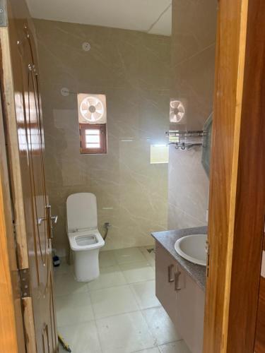 a small bathroom with a toilet and a sink at The elf stays in Dehradun