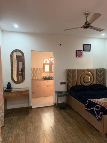 a bedroom with a bed and a mirror and a sink at The elf stays in Dehradun