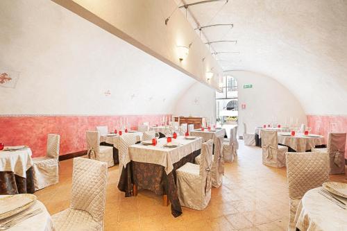 a dining room with tables and chairs in a room at Castello Di Compiano Hotel Relais Museum in Compiano