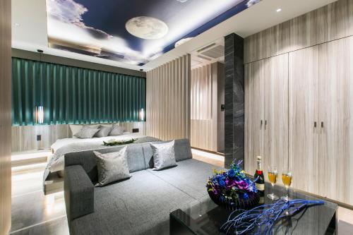 a living room with a bed and a couch at Hotel The Moon -Adult Only- in Okayama