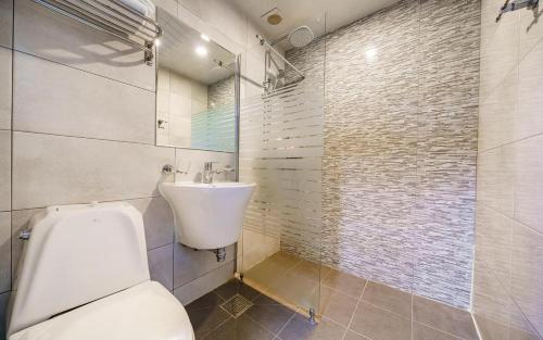a bathroom with a toilet and a sink at Hotel Remi in Seoul
