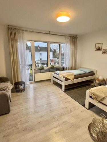a living room with two beds and a window at FeWo mit Terrasse Neuwied & Koblenz in Neuwied