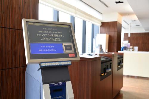a computer monitor on a stand in a room at Hotel Gracery Sapporo in Sapporo