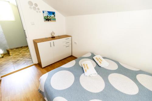 a bedroom with a bed with two pillows on it at Drinski sjaj in Ljubovija