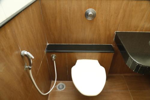 a bathroom with a toilet and a shower at HOTEL GRAND PLAZzA in Coimbatore