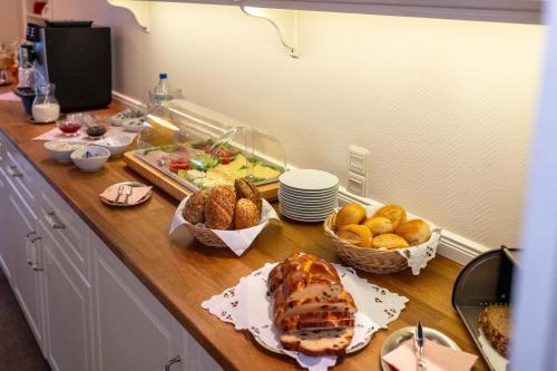 a kitchen counter with a table with food on it at Haus Geistmeier in Lippstadt