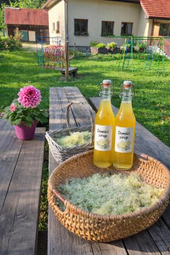 two bottles of orange juice on a picnic table at Črjanski Raj in Črna na Koroškem