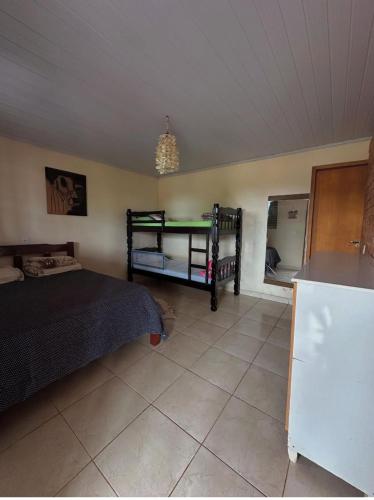 a bedroom with two bunk beds and a refrigerator at Rancho Corumba VI in Alexânia