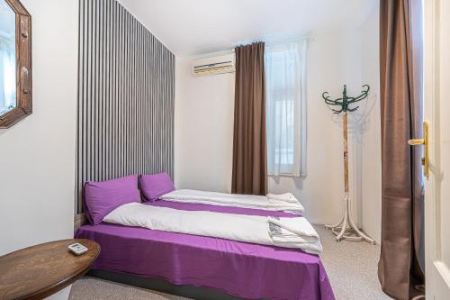 a bedroom with a purple bed and a window at Central House for up to 20 Guests Entire Place in Sofia