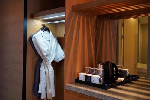 a hotel room with a bathroom with a mirror at Hotel Tour Incheon Airport Hotel & Suites in Incheon