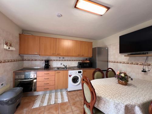 a small kitchen with a table and a microwave at Quinta dos Viegas in Faro