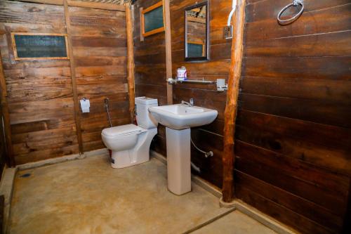 a bathroom with a toilet and a sink at Nature Win Yala in Hambantota