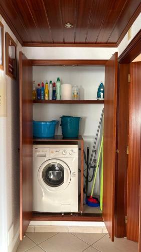 a kitchen with a washing machine in a cabinet at Monte Gordo T1 - Estrela do Mar in Monte Gordo
