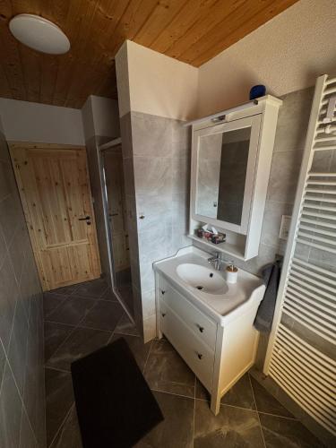 a bathroom with a sink and a shower at Drevenica MATAJKA in Kvačany