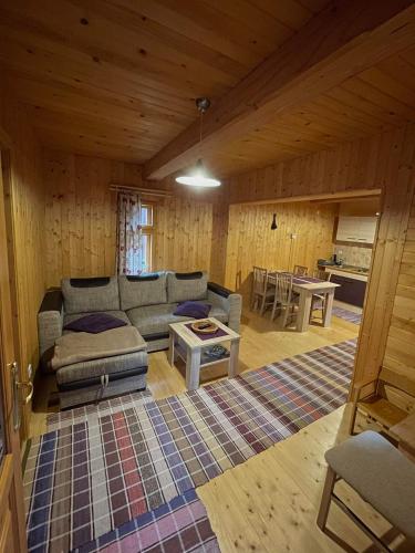 a living room with a couch and a table at Drevenica MATAJKA in Kvačany