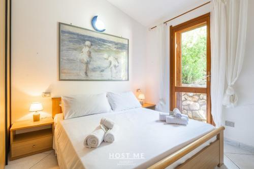 a bedroom with a bed with two towels on it at Terrazza 12 - Free Wifi in Costa Rei