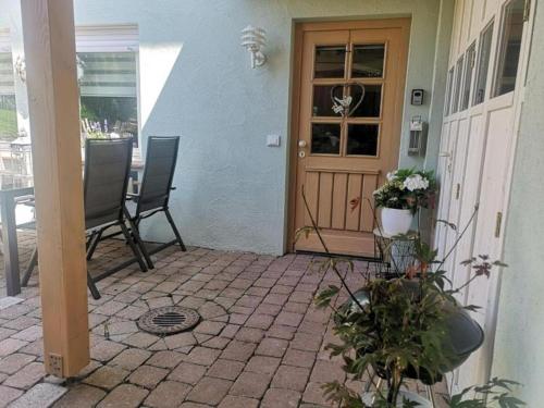 a front door of a house with a table and chairs at Ferienwohnung Schmuckkästchen in Calw