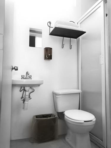 a bathroom with a toilet and a sink at Casa Zapopan Hotel in Guadalajara