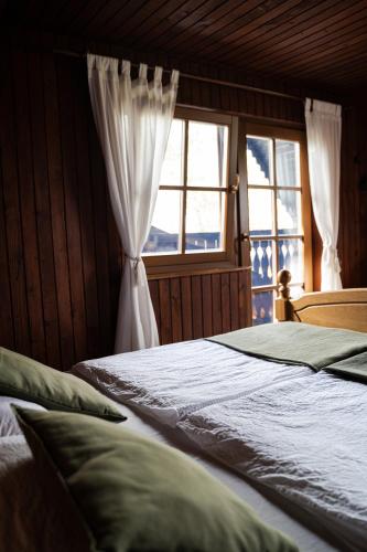a bedroom with a bed and a window at Countryside cottage with mountain view in Lukovica pri Domžalah