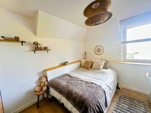 a bedroom with a bed with a teddy bear on it at Écrin Ostwald 2 private suites Free parking in Ostwald