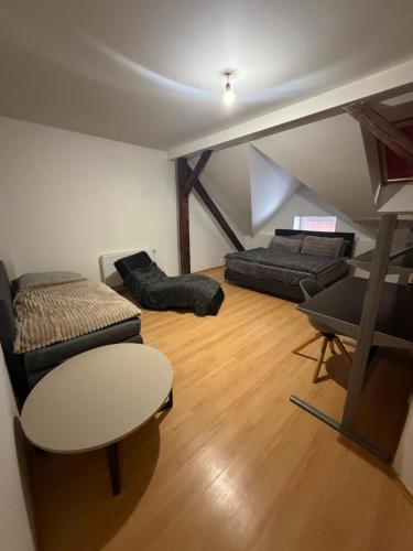 a living room with two beds and a table at Pilsen flat in Pilsen