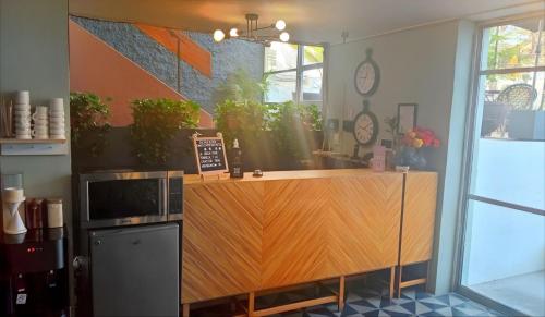 a kitchen with a wooden counter with a microwave at Casa Zapopan Hotel in Guadalajara