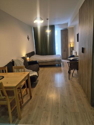 a living room with a couch and a table at Bakuriani Plaza A block N109 in Bakuriani