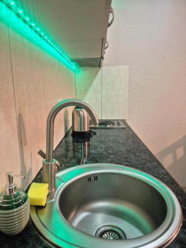 a kitchen sink with a green light above it at Bakuriani Plaza A block N109 in Bakuriani