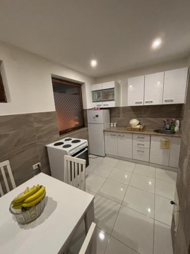 a kitchen with a table with bananas on it at Stan na dan in Pljevlja