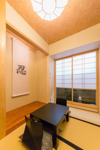 a room with a black table and a window at SARASA HOTEL Namba in Osaka
