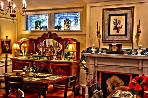 a dining room with a table and a fireplace at Big Yellow Inn in Cedar City
