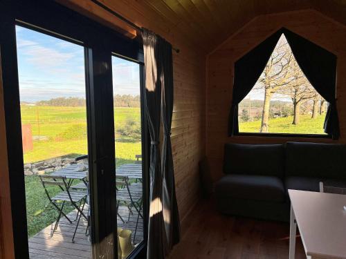 a room with a window and a couch and a table at Quinta da Runa by Tiny Away in Bagunte