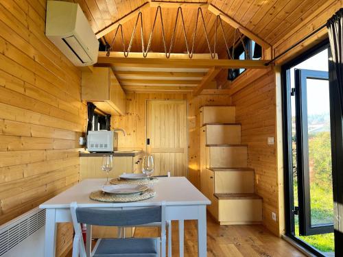 a small kitchen with a table and chairs in a tiny house at Quinta da Runa by Tiny Away in Bagunte