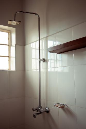 a shower with a glass door in a bathroom at Kitopua suites in Arusha