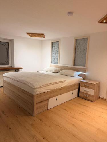 a bedroom with a large bed and two windows at KM Apparts 2 Wesel in Wesel