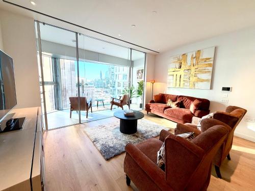 a living room with a couch and a table at Battersea Power Apartments in London