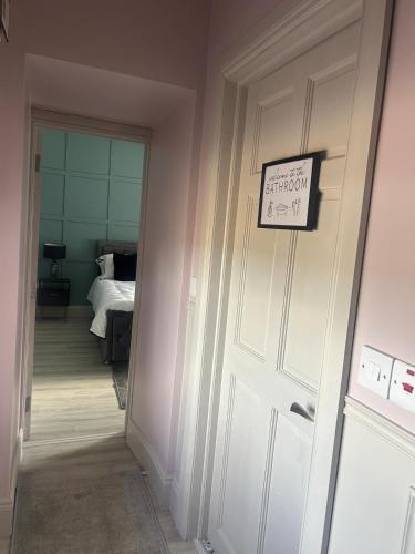 a door to a bedroom with a sign on it at Clontrain Cottage in Carrickmacross