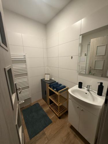 a bathroom with a sink and a mirror at Apartmán LUNA Choceň in Choceň
